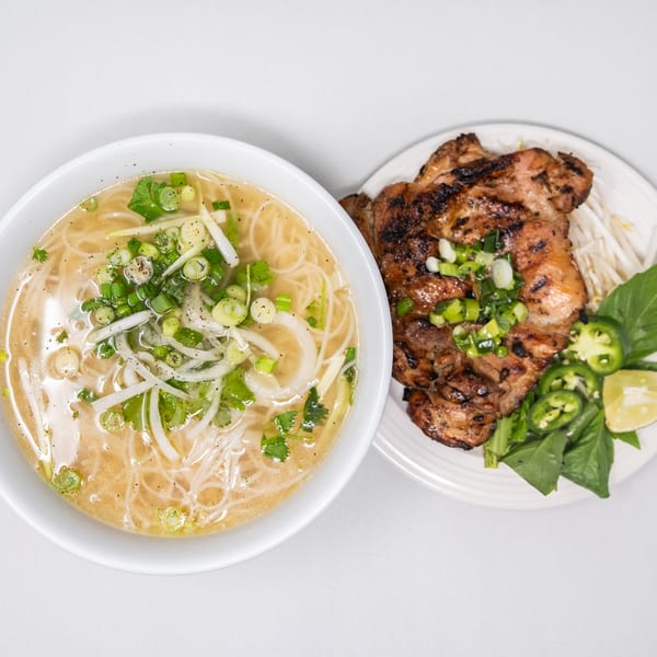 Pho Vietnam's chicken pho with a side of grilled chicken, bean sprouts, basil, jalapeños, and lime.